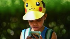 Leo, 9, looks at his phone during the Pokemon Go Festival on July 4, 2019 at the Westfalenpark in Dortmund, western Germany.