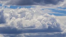 A photo of a blue sky with puffy clouds