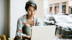 A student using one of the best laptops for students in a coffee shop