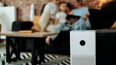 An air purifier sitting in the middle of a living room