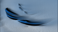 Visualization of the sand dune shaped ice structures, with three large and three small curves of dark under the ice